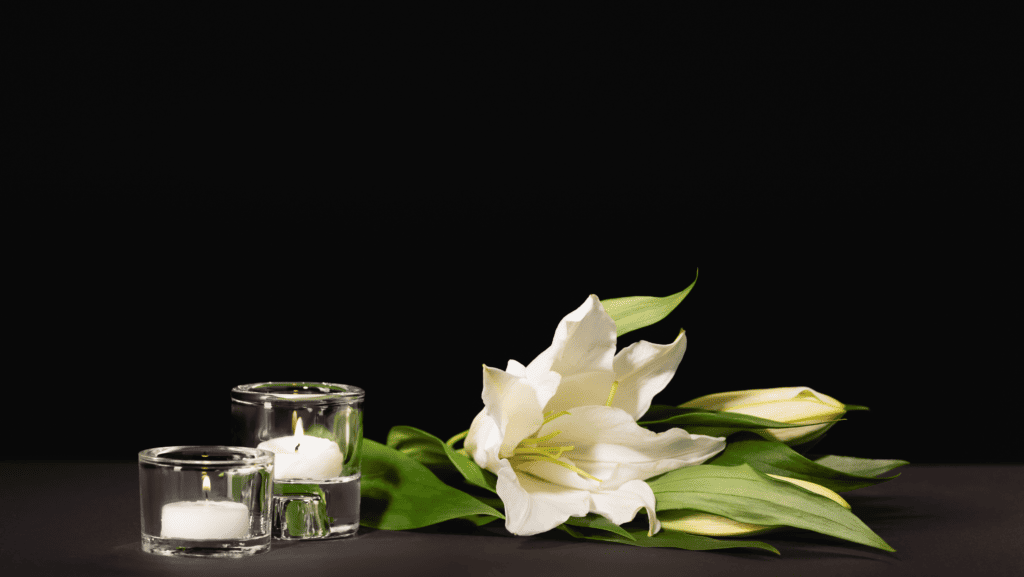 A lily and candles at a funeral